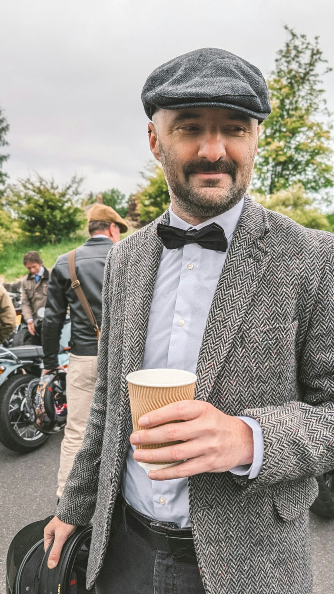 Studio portrait of a Uruguayan man in his mid-forties, automotive historian, wearing a tweed jacket