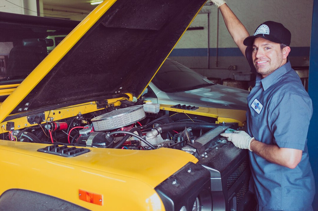 mechanic checking car engine