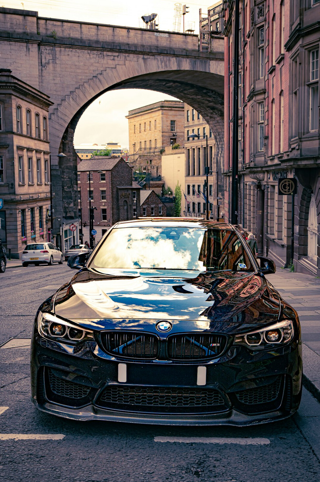 black luxury sedan on city street
